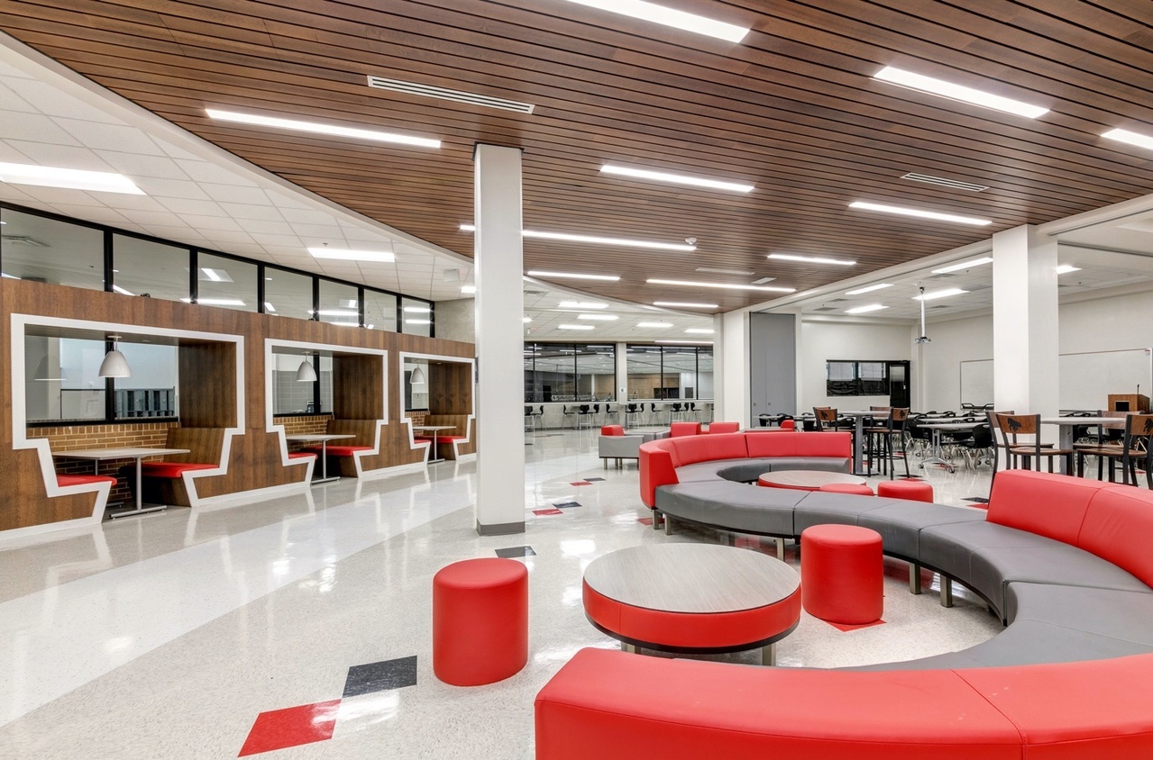 Booths, red couches, and ceiling lighting