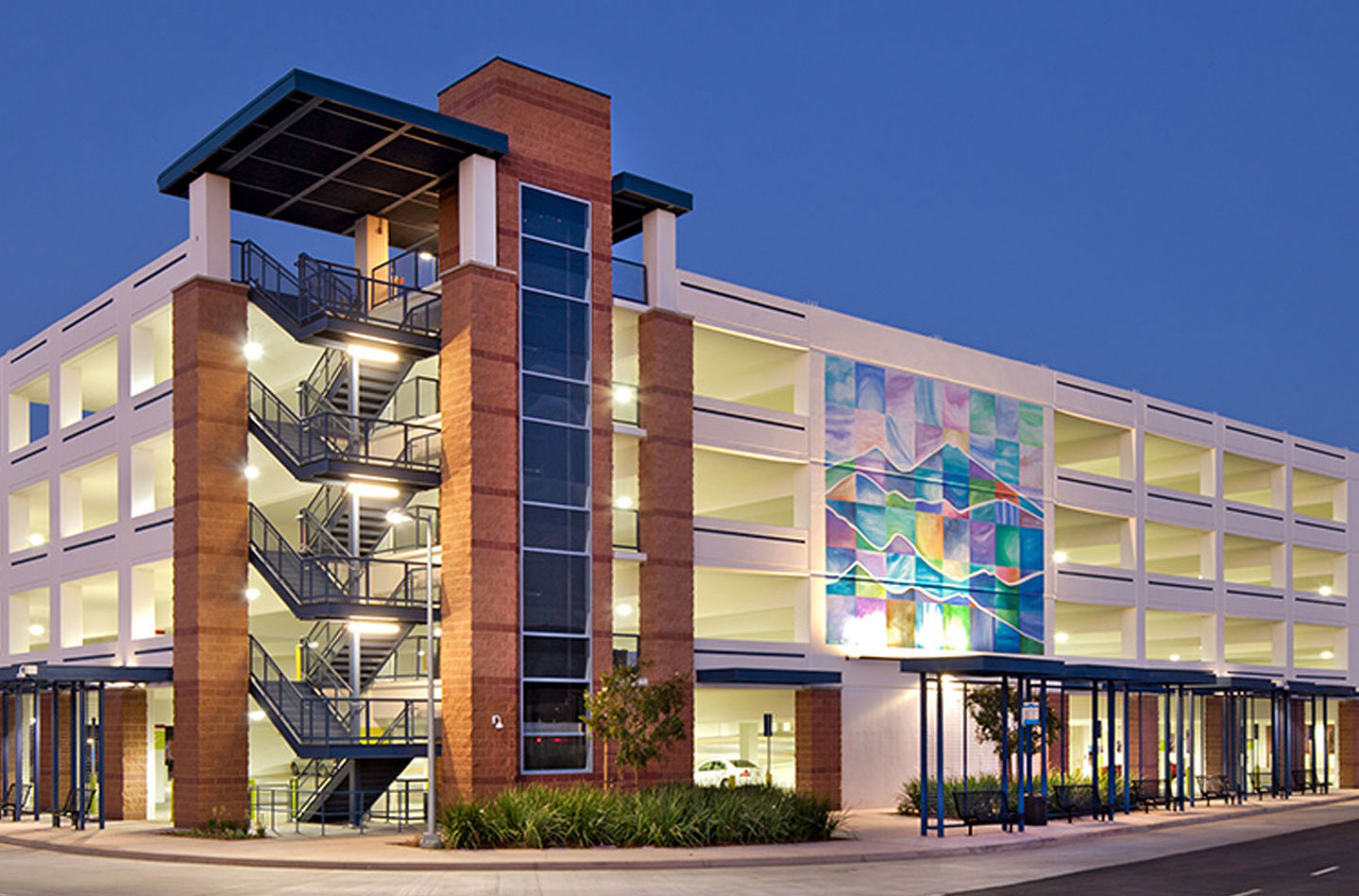 Lighting for parking garage with painting on one side
